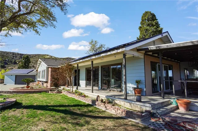 a view of a house with backyard porch and sitting area