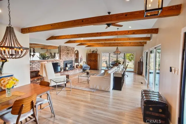 a dining room with furniture a fireplace and wooden floor