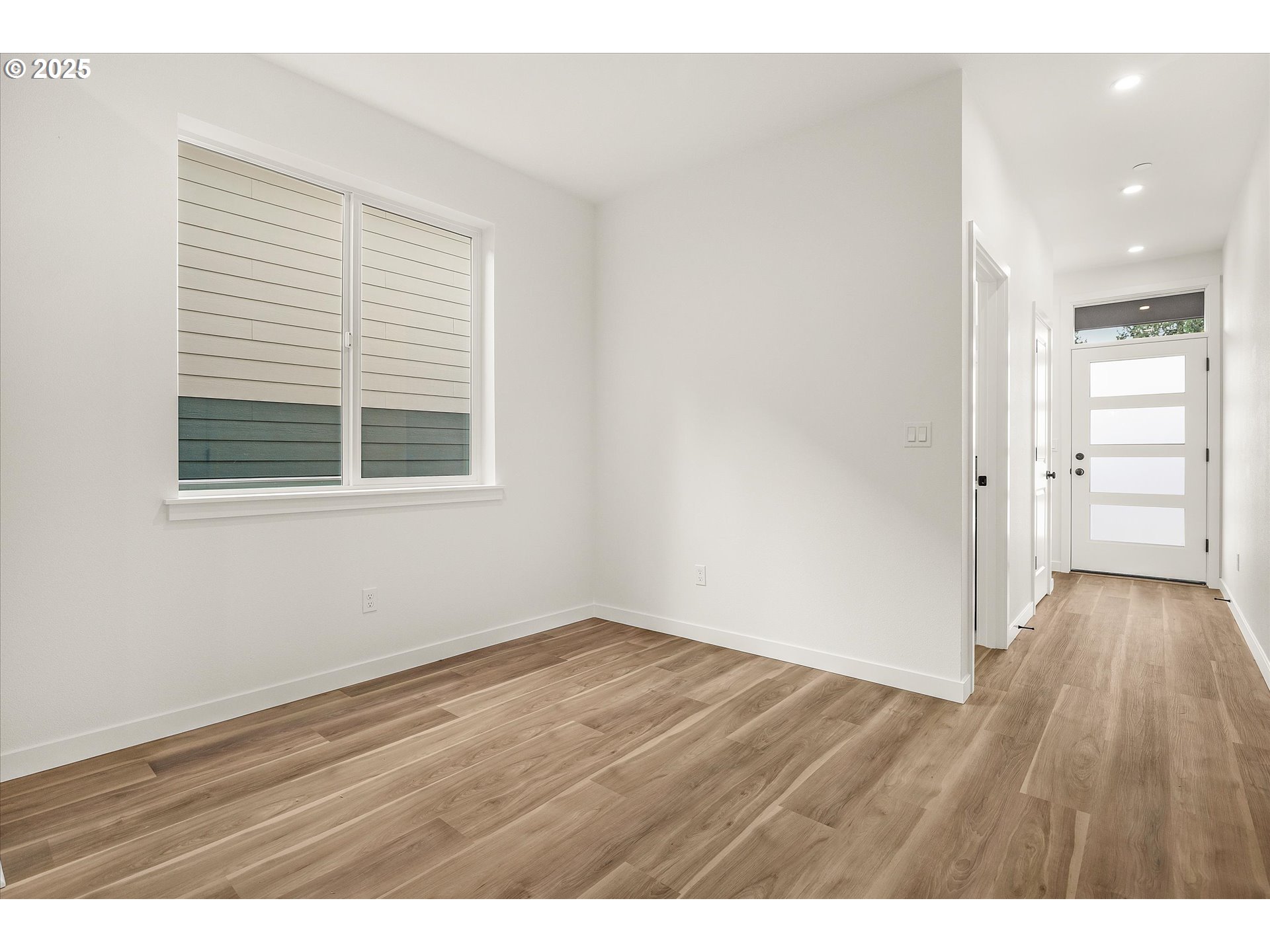 284 Northwest Mawrcrest Drive Gresham, OR 97030 - Photo 21 of 37 a view of an empty room with wooden floor and a window