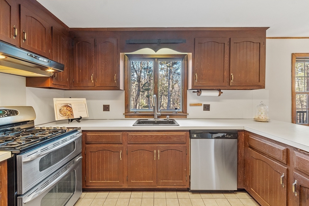 31 Mohawk Road Andover, MA 01810 - Photo 16 of 33 a kitchen with cabinets appliances a sink and a window