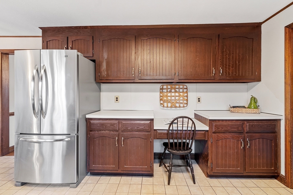 31 Mohawk Road Andover, MA 01810 - Photo 17 of 33 a kitchen with a refrigerator and a stove top oven