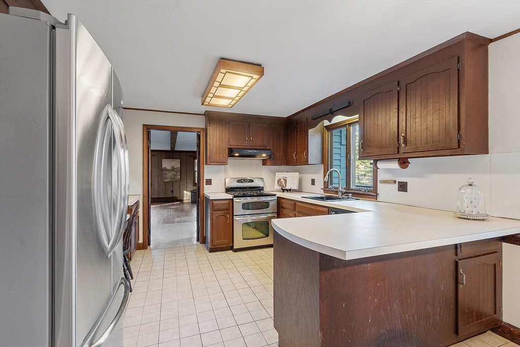 31 Mohawk Road Andover, MA 01810 - Photo 18 of 33 a kitchen with a sink refrigerator and cabinets