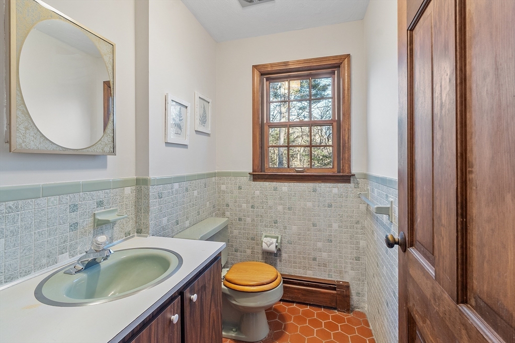 31 Mohawk Road Andover, MA 01810 - Photo 21 of 33 a bathroom with a sink a toilet and a mirror