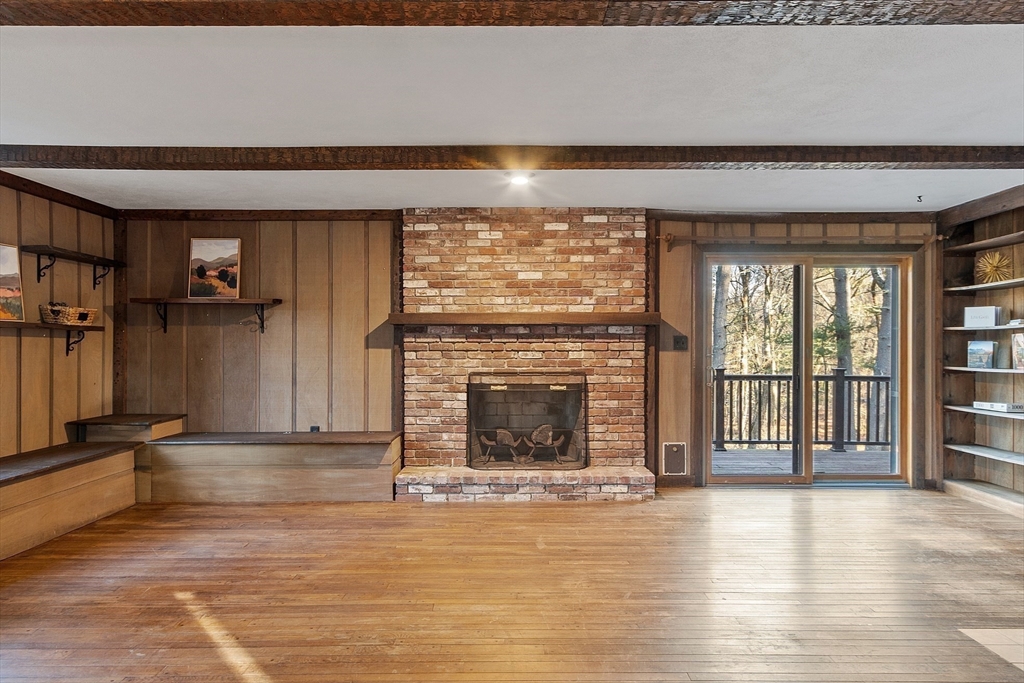31 Mohawk Road Andover, MA 01810 - Photo 8 of 33 a view of an empty room with wooden floor and a fireplace