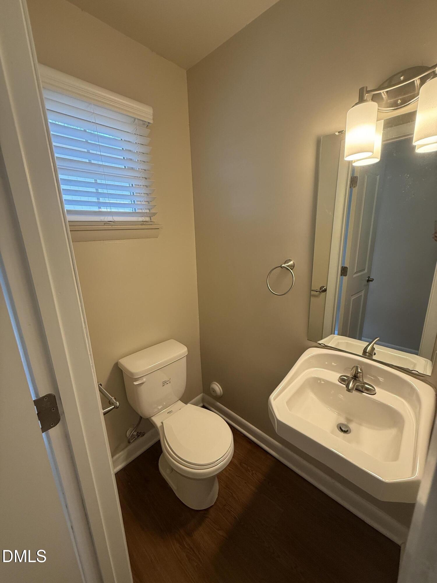 2616 Noble Road, Unit D Raleigh, NC 27608 - Photo 4 of 9 a bathroom with a sink a toilet and mirror
