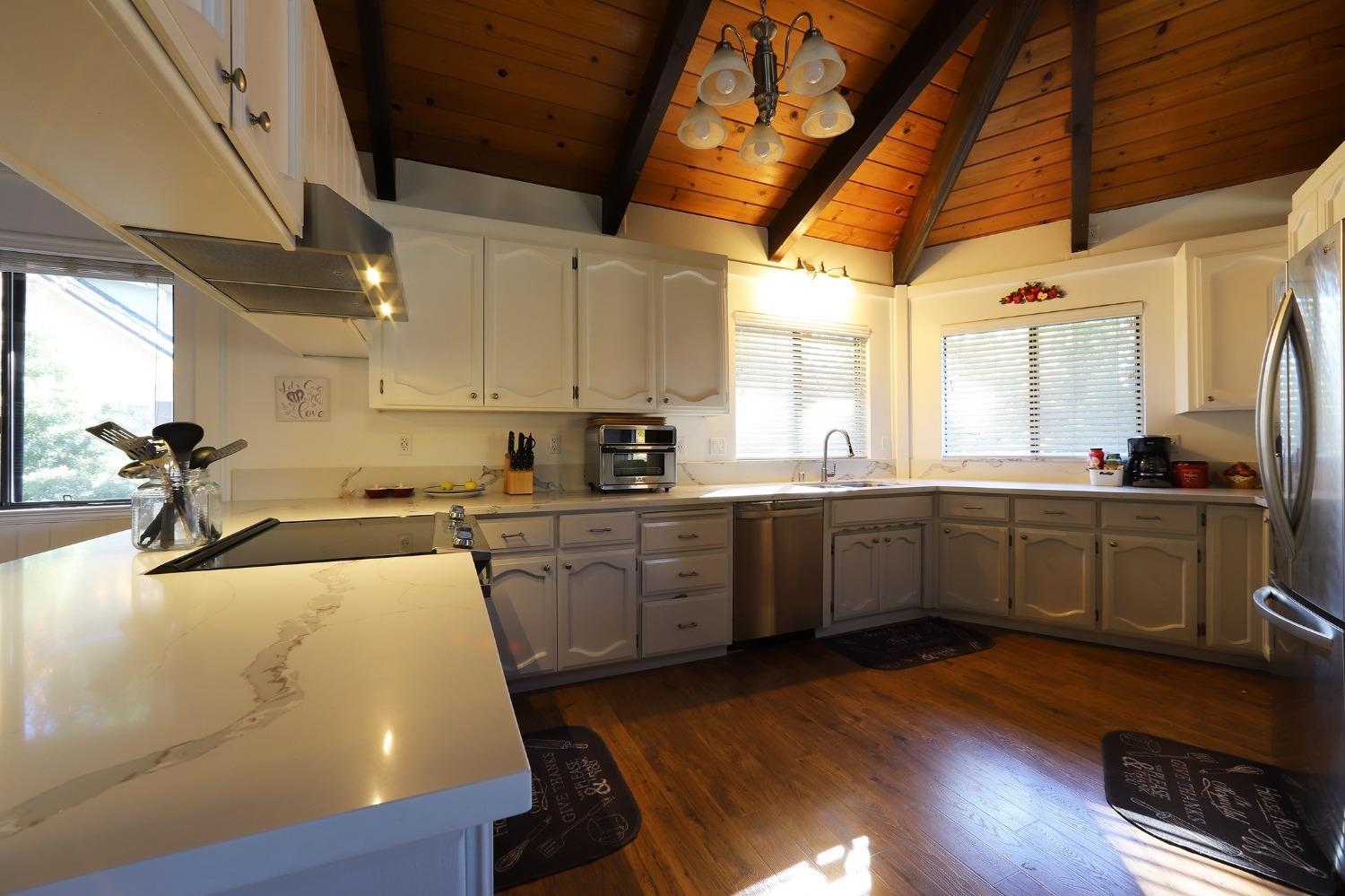 1870 Cable Road Camino, CA 95709 - Photo 24 of 36 a kitchen with sink cabinets and wooden floor