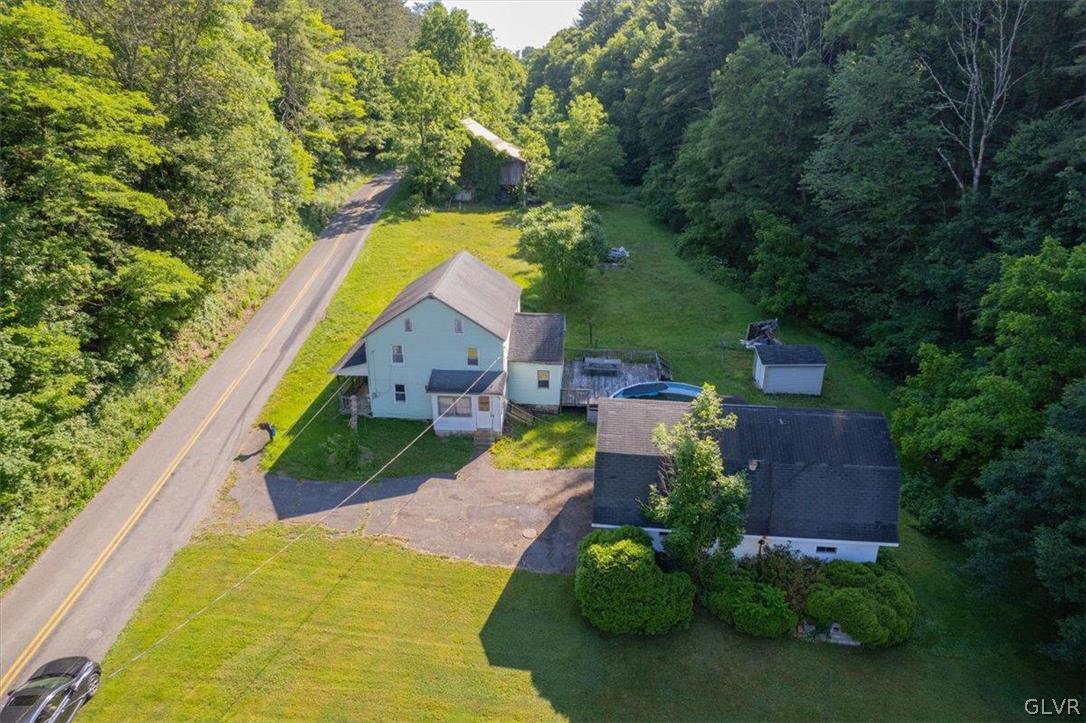 an aerial view of a house with a yard and outdoor seating