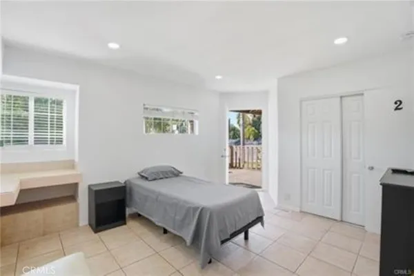 a bedroom with two beds and a window
