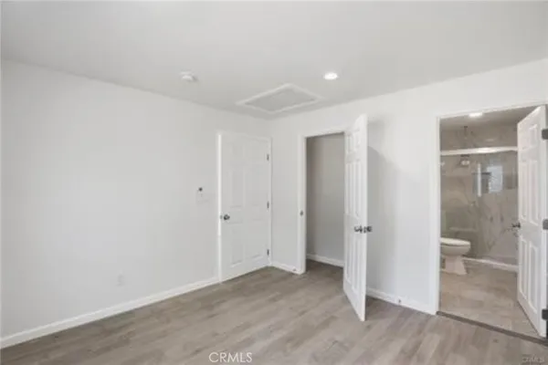 a bedroom with a bed and a closet