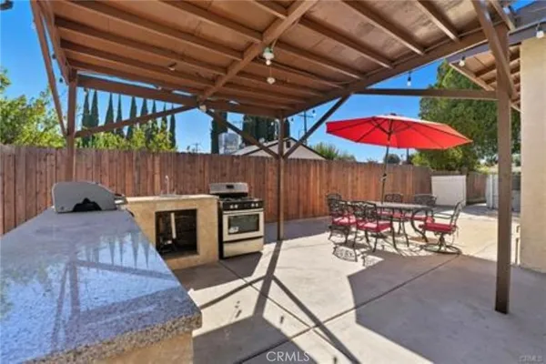 a view of a house with backyard and sitting area