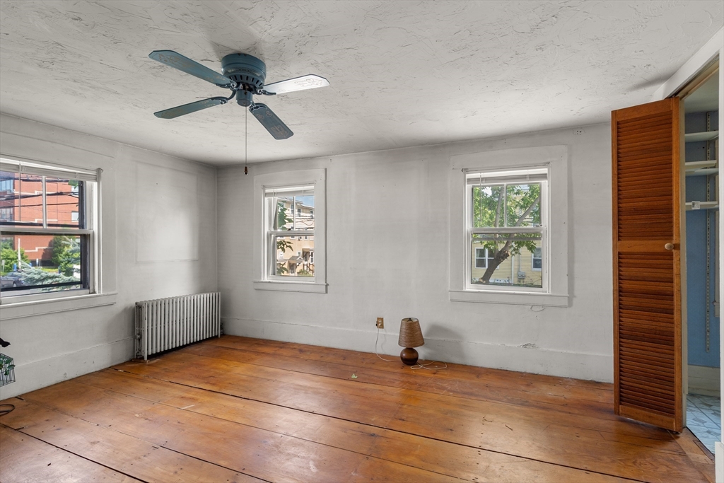 49 Summer Street Natick, MA 01760 - Photo 12 of 39 a view of an empty room with a window and wooden floor