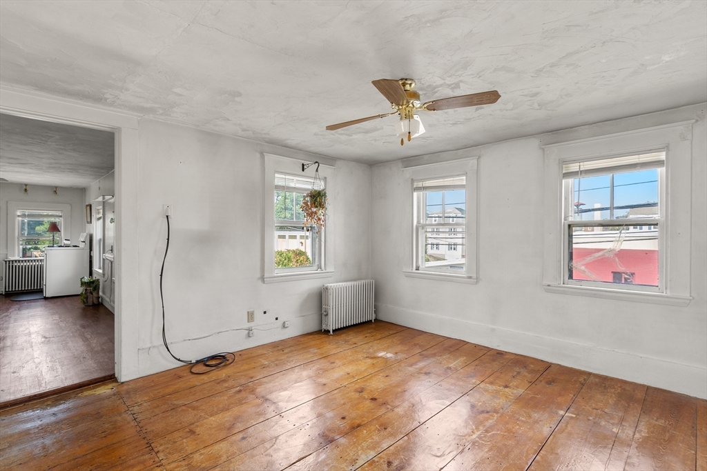49 Summer Street Natick, MA 01760 - Photo 13 of 39 a view of empty room with wooden floor and fan
