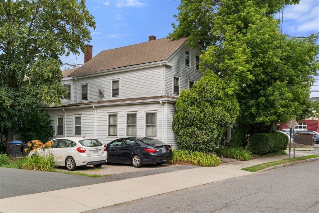 49 Summer Street Natick, MA 01760 - Photo 16 of 39 a car parked in front of a white house
