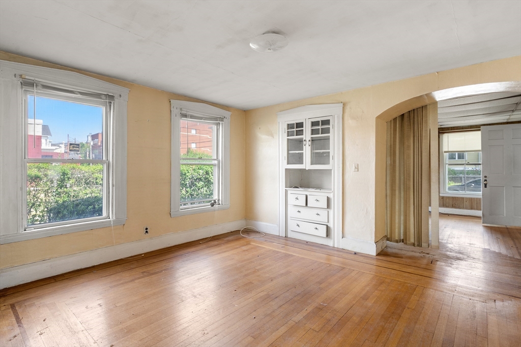 49 Summer Street Natick, MA 01760 - Photo 7 of 39 an empty room with wooden floor and windows