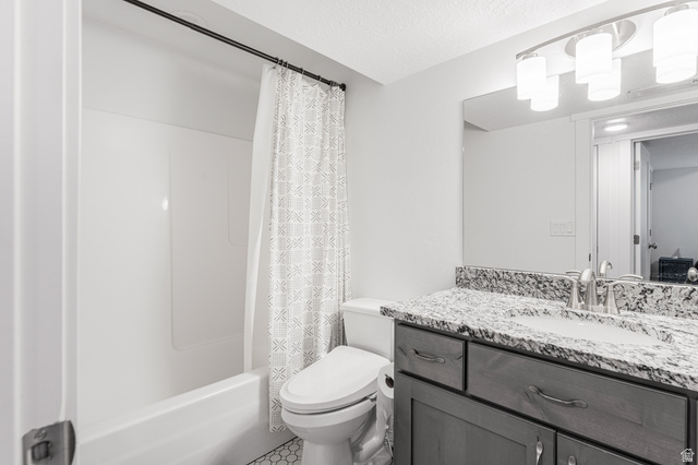 313 Old Maple Road South Weber, UT 84405 - Photo 23 of 35 Bathroom featuring a white tub-shower combination, a vanity with a light-colored countertop, and a built-in mirror