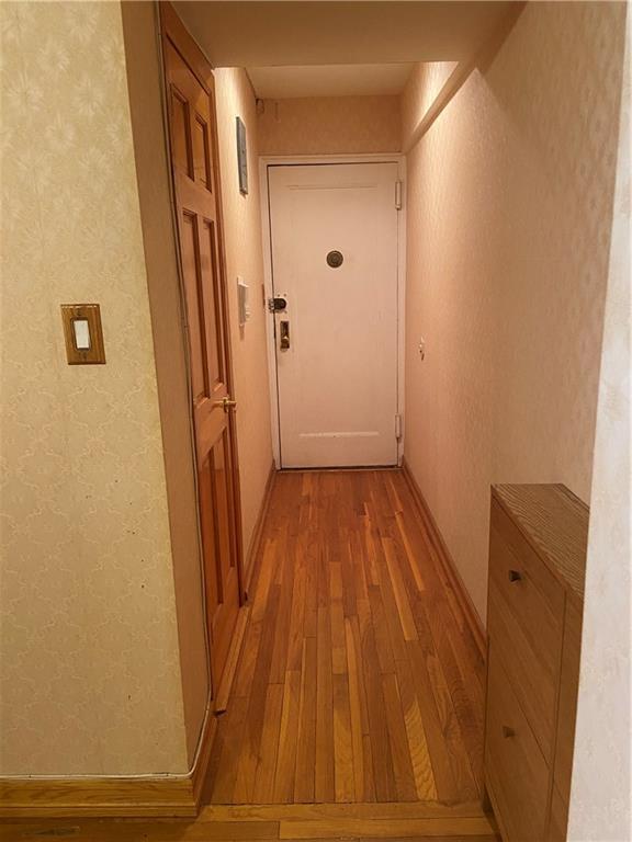 7259 Shore Road, Unit 2K Brooklyn, NY 11209 - Photo 12 of 19 a view of a room with wooden floor and staircase