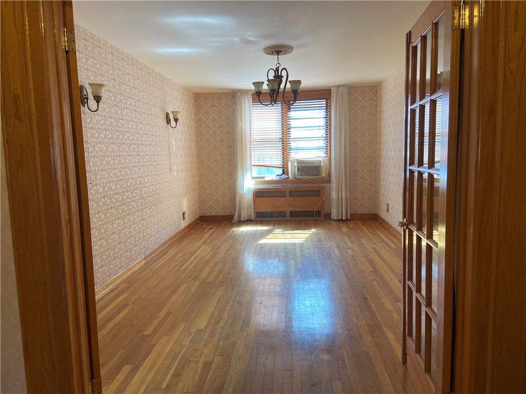 7259 Shore Road, Unit 2K Brooklyn, NY 11209 - Photo 7 of 19 a view of empty room with wooden floor and fan