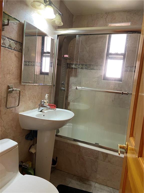 7259 Shore Road, Unit 2K Brooklyn, NY 11209 - Photo 10 of 19 a bathroom with a sink toilet and shower