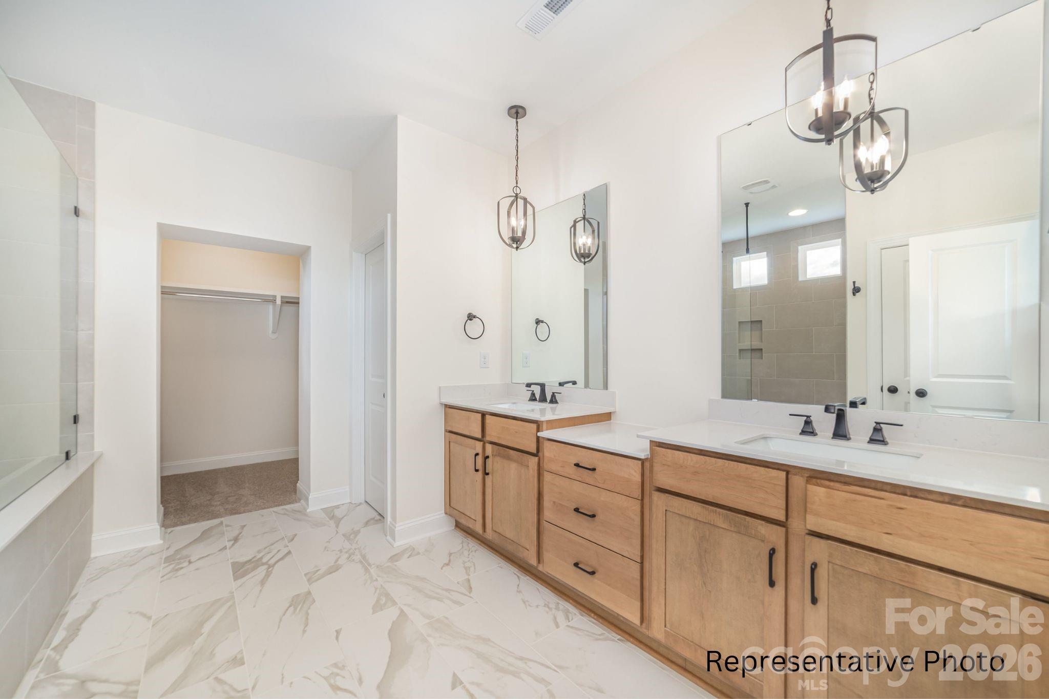 4172 Millstream Road, Unit 137 Denver, NC 28037 - Photo 11 of 28 a spacious bathroom with a double vanity sink shower and a mirror
