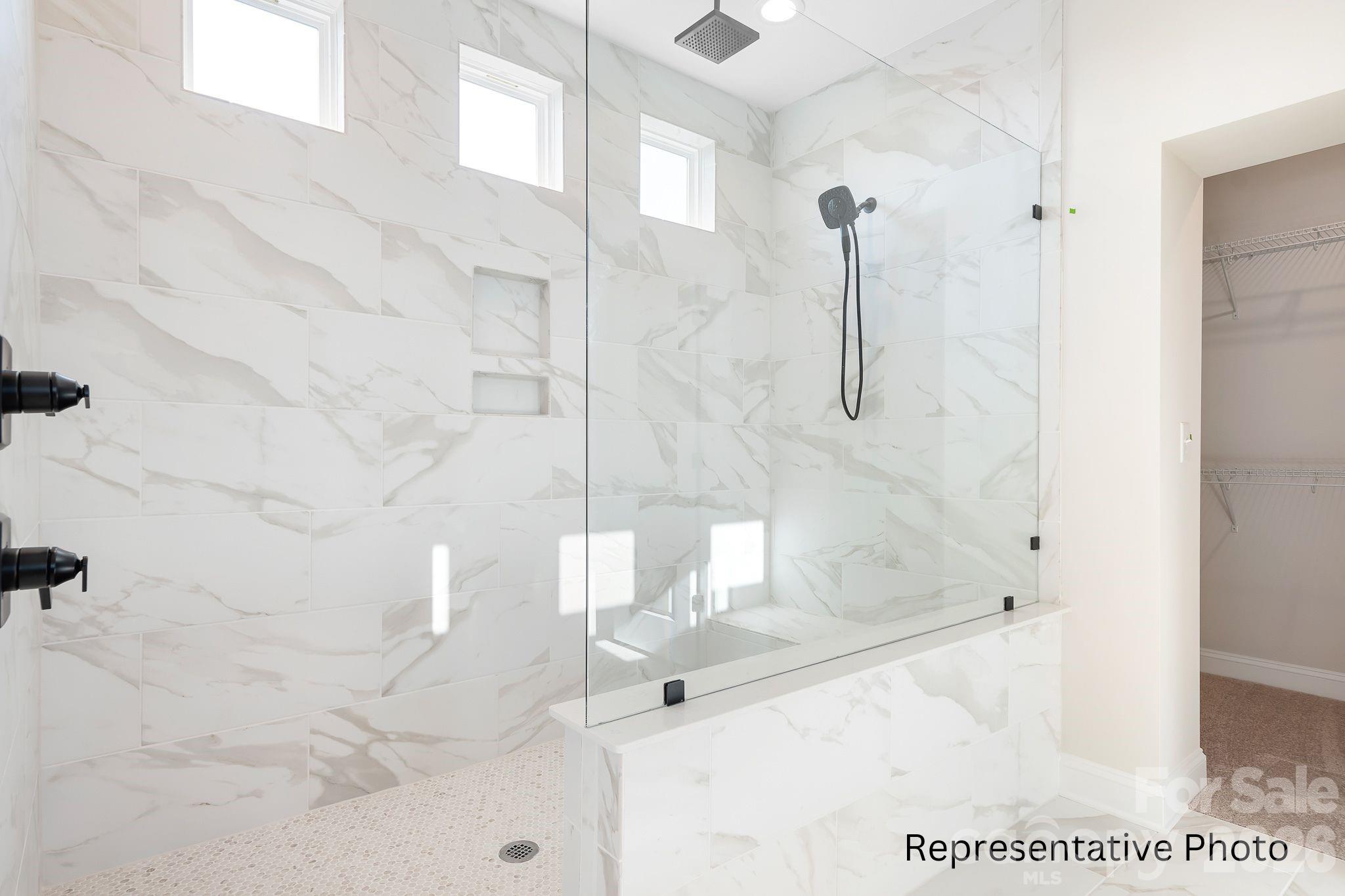 4172 Millstream Road, Unit 137 Denver, NC 28037 - Photo 12 of 28 a bathroom with a glass shower door