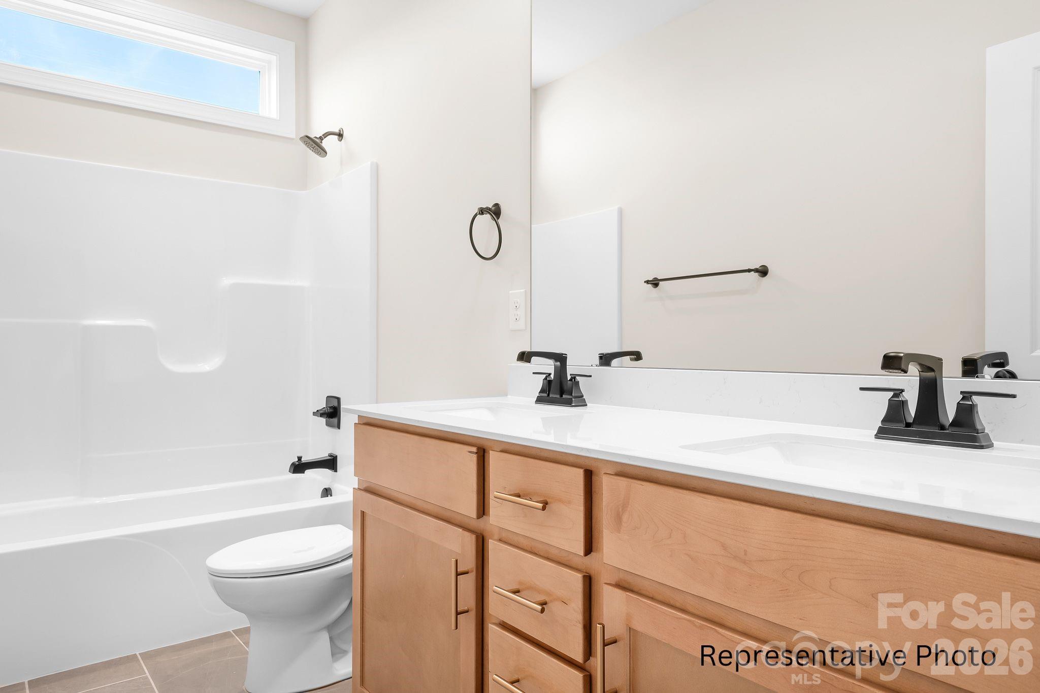 4172 Millstream Road, Unit 137 Denver, NC 28037 - Photo 15 of 28 a bathroom with a sink a toilet and shower