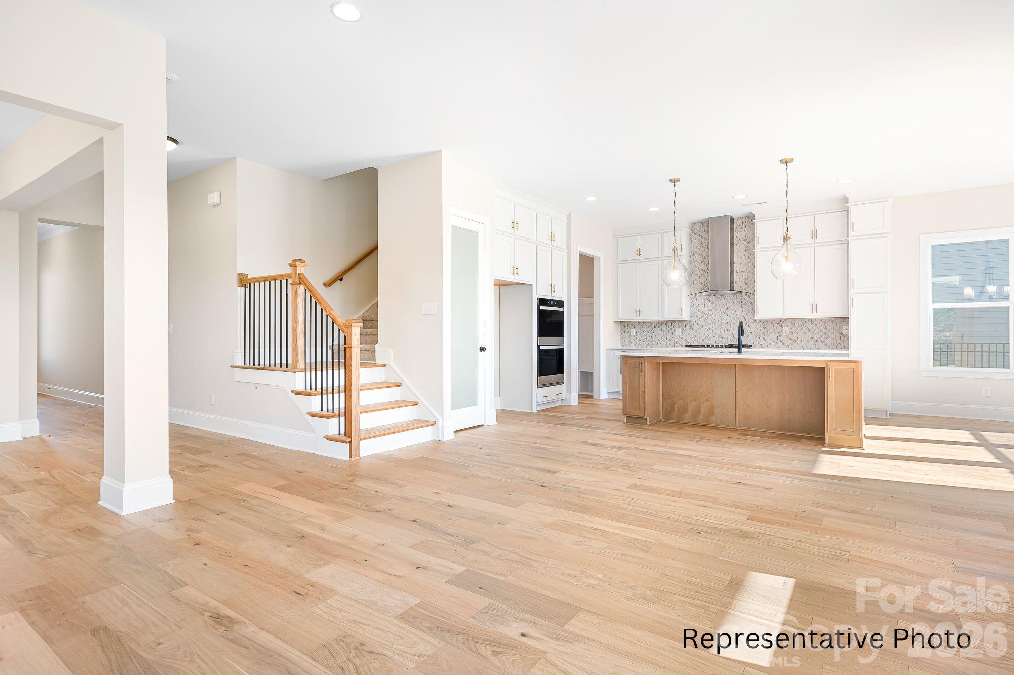 4172 Millstream Road, Unit 137 Denver, NC 28037 - Photo 2 of 28 a view of a livingroom with kitchen and staircase