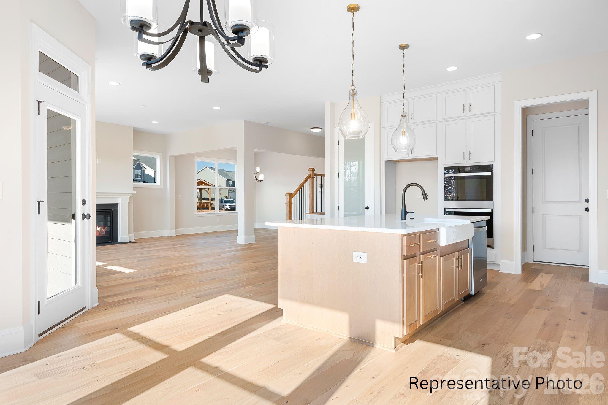 4172 Millstream Road, Unit 137 Denver, NC 28037 - Photo 4 of 28 a large kitchen with stainless steel appliances kitchen island a large counter a sink and a refrigerator