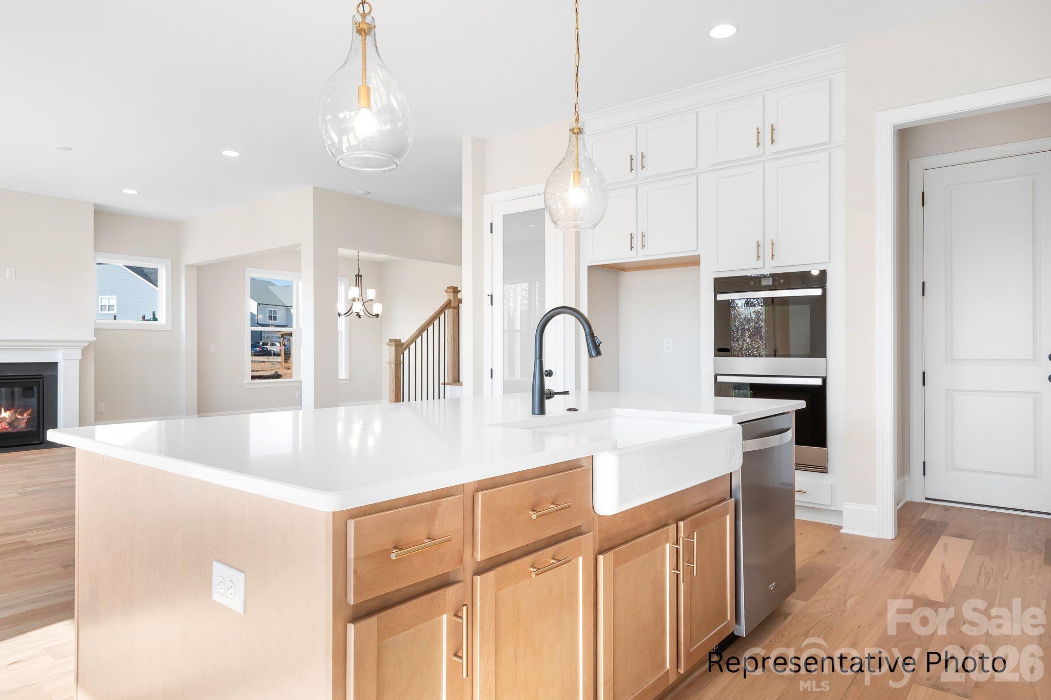 4172 Millstream Road, Unit 137 Denver, NC 28037 - Photo 5 of 28 a kitchen with stainless steel appliances granite countertop a sink a stove and a refrigerator