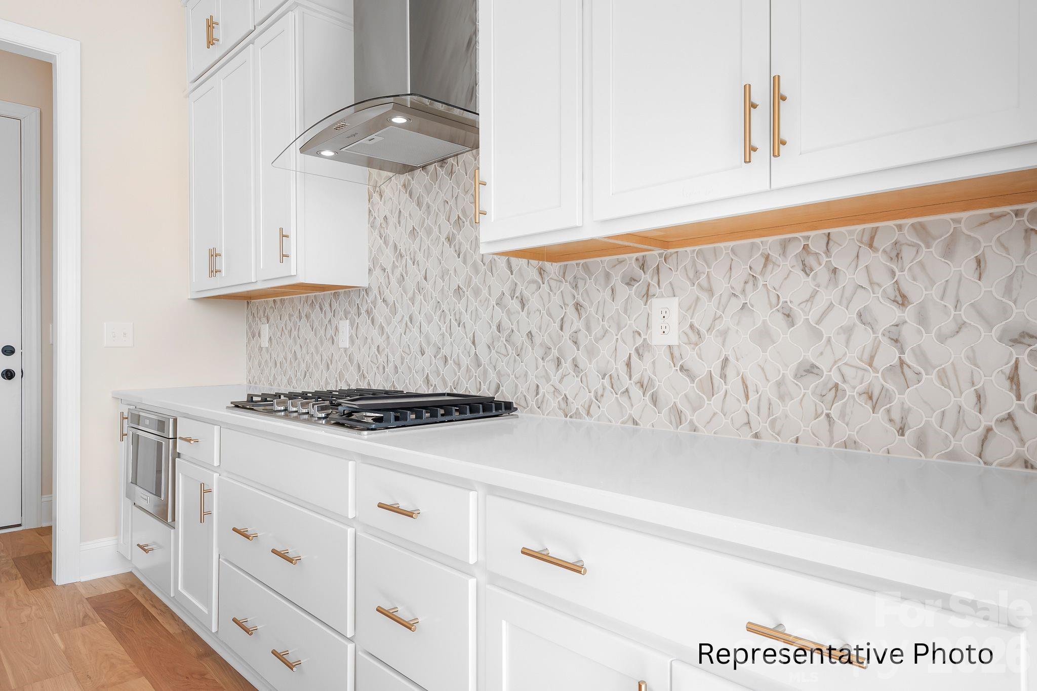 4172 Millstream Road, Unit 137 Denver, NC 28037 - Photo 7 of 28 a kitchen with white cabinets and white appliances