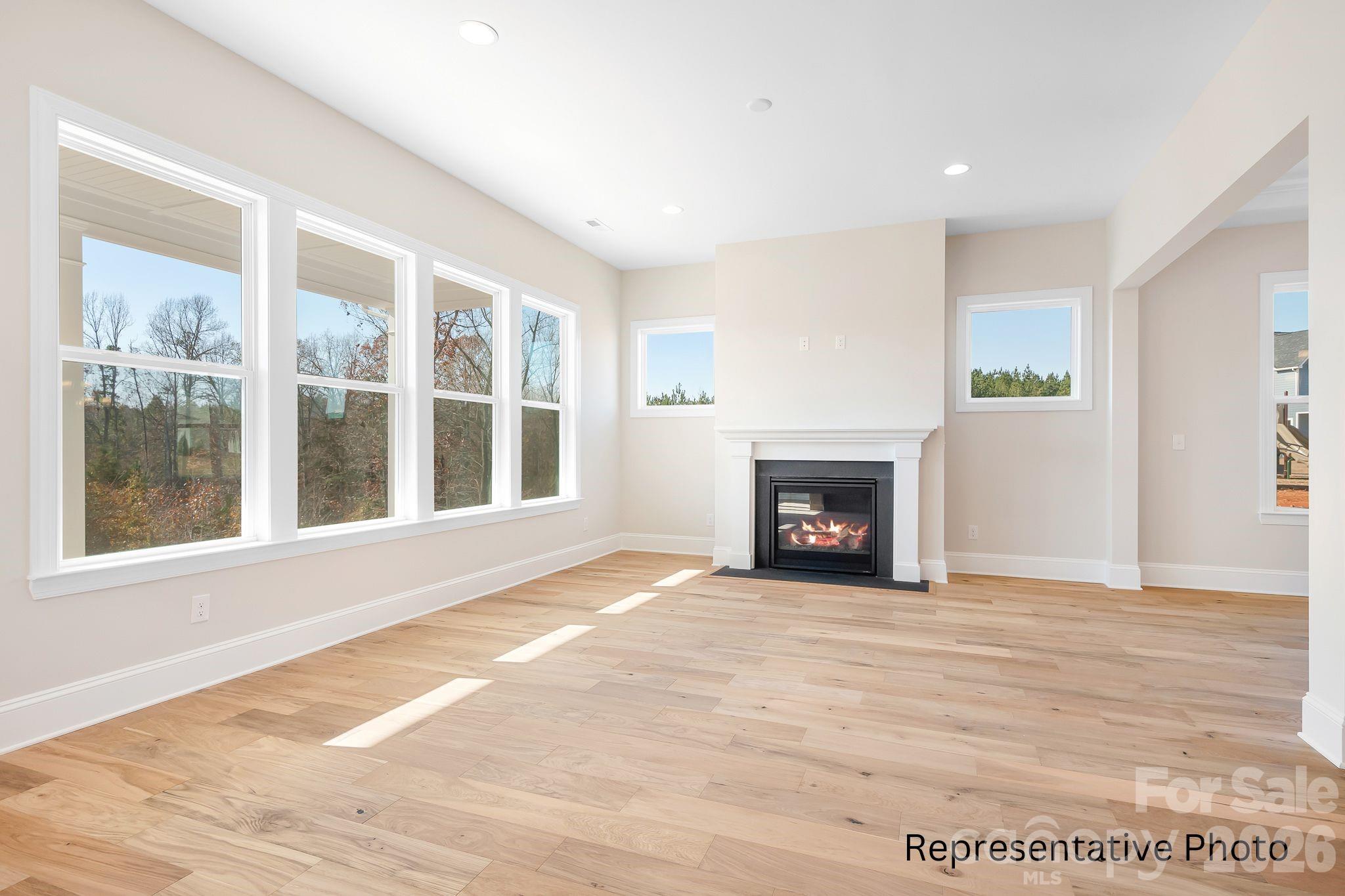 4172 Millstream Road, Unit 137 Denver, NC 28037 - Photo 8 of 28 a view of an empty room with a window and a fireplace