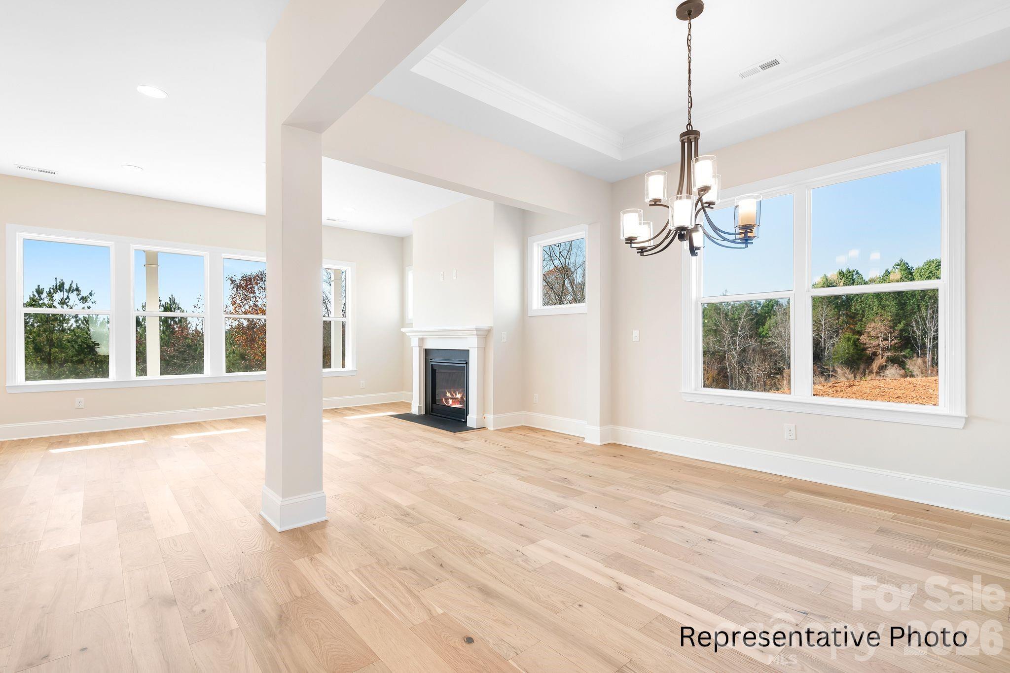 4172 Millstream Road, Unit 137 Denver, NC 28037 - Photo 9 of 28 a view of an empty room with wooden floor and a window