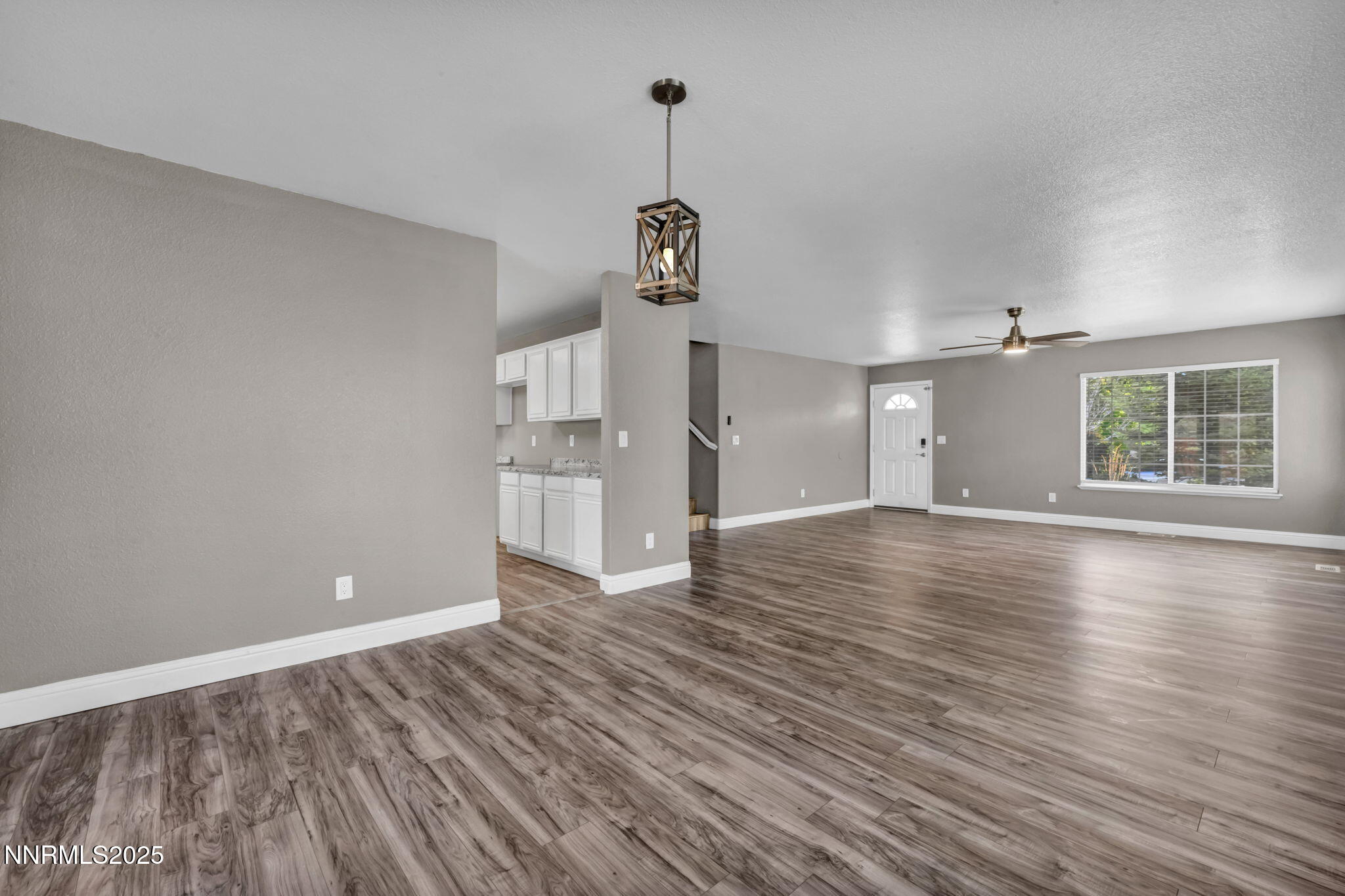 17391 Crystal Canyon Boulevard Reno, NV 89508 - Photo 13 of 63 a view of empty room with wooden floor and window