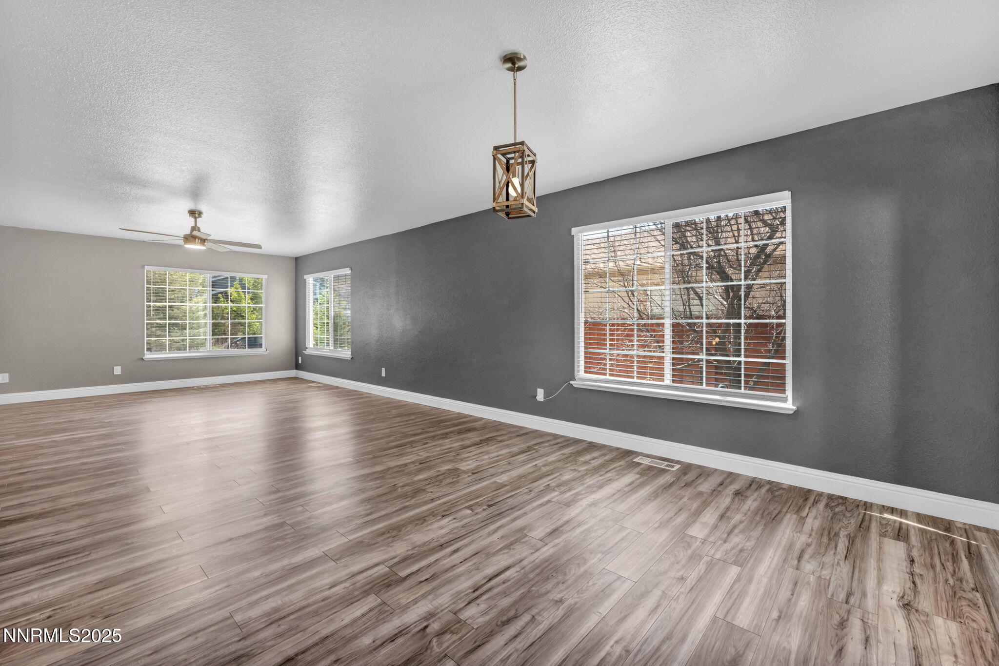 17391 Crystal Canyon Boulevard Reno, NV 89508 - Photo 18 of 63 a view of an empty room with wooden floor and a window