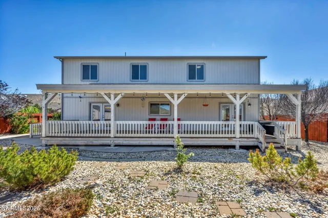 a view of a house with a wooden deck