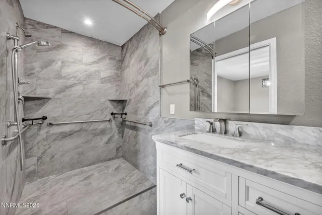 a bathroom with a granite countertop sink a toilet and a mirror