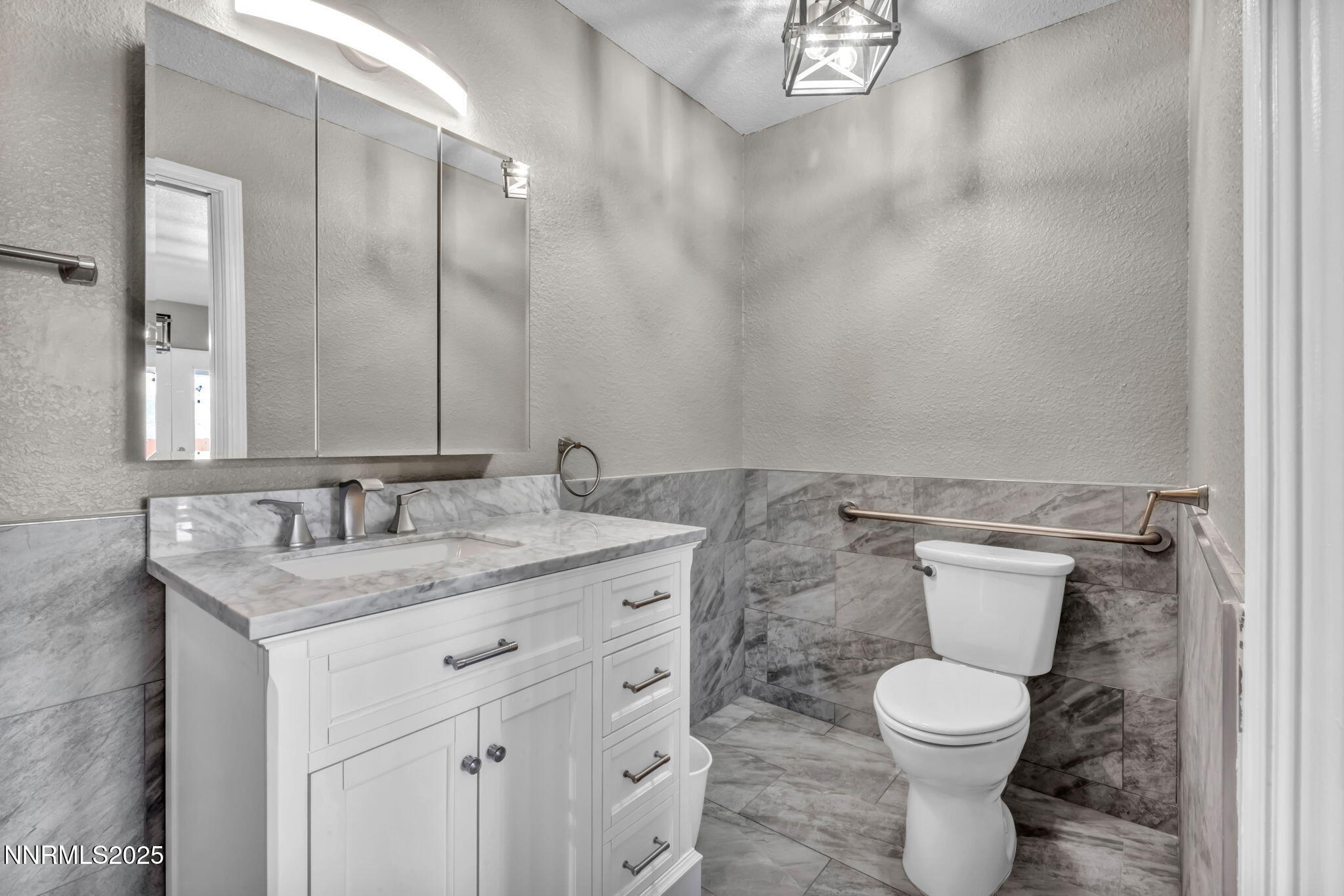 17391 Crystal Canyon Boulevard Reno, NV 89508 - Photo 23 of 63 a bathroom with a granite countertop sink a toilet and a mirror