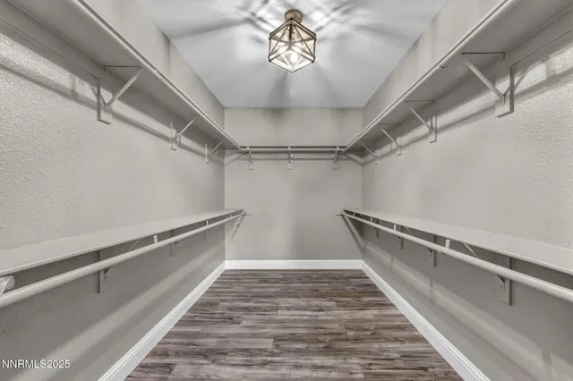 a spacious bathroom with a granite countertop sink and a mirror