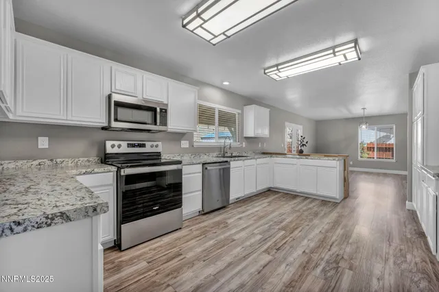 a kitchen with a white cabinets and stainless steel appliances