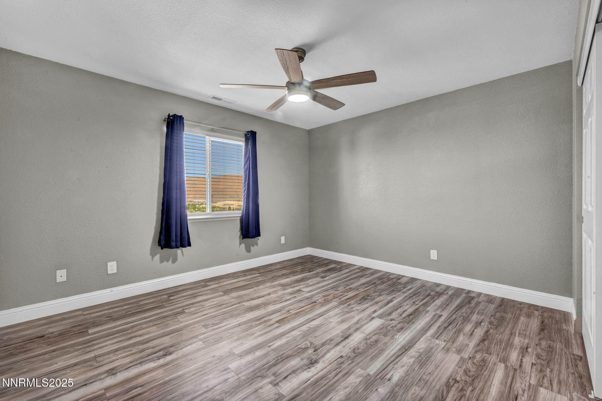 17391 Crystal Canyon Boulevard Reno, NV 89508 - Photo 35 of 63 wooden floor in an empty room with a window