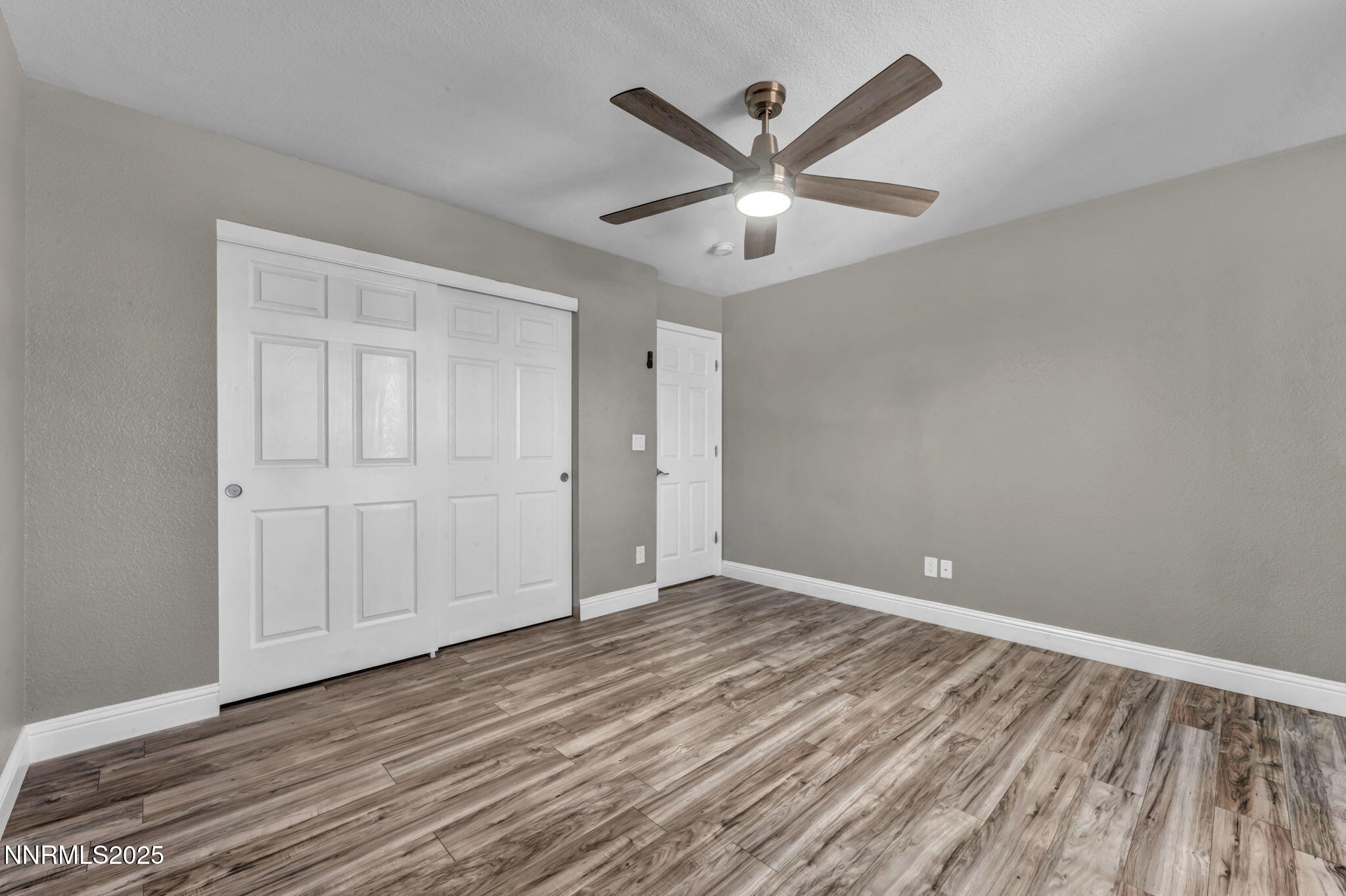 17391 Crystal Canyon Boulevard Reno, NV 89508 - Photo 36 of 63 an empty room with wooden floor closet and fan