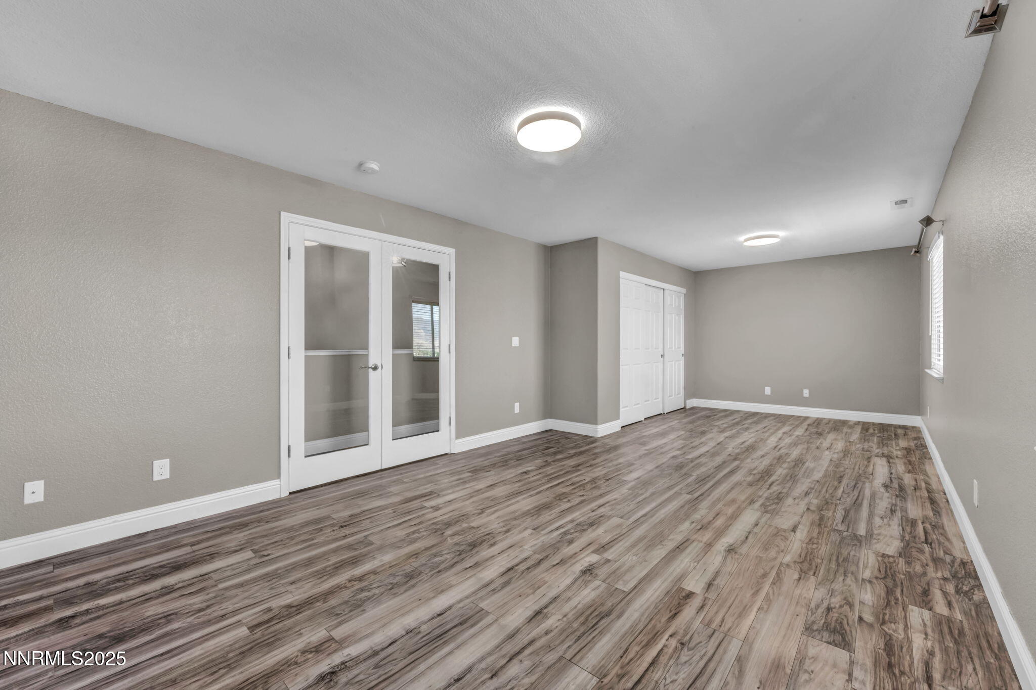 17391 Crystal Canyon Boulevard Reno, NV 89508 - Photo 38 of 63 a view of an empty room with wooden floor and a window