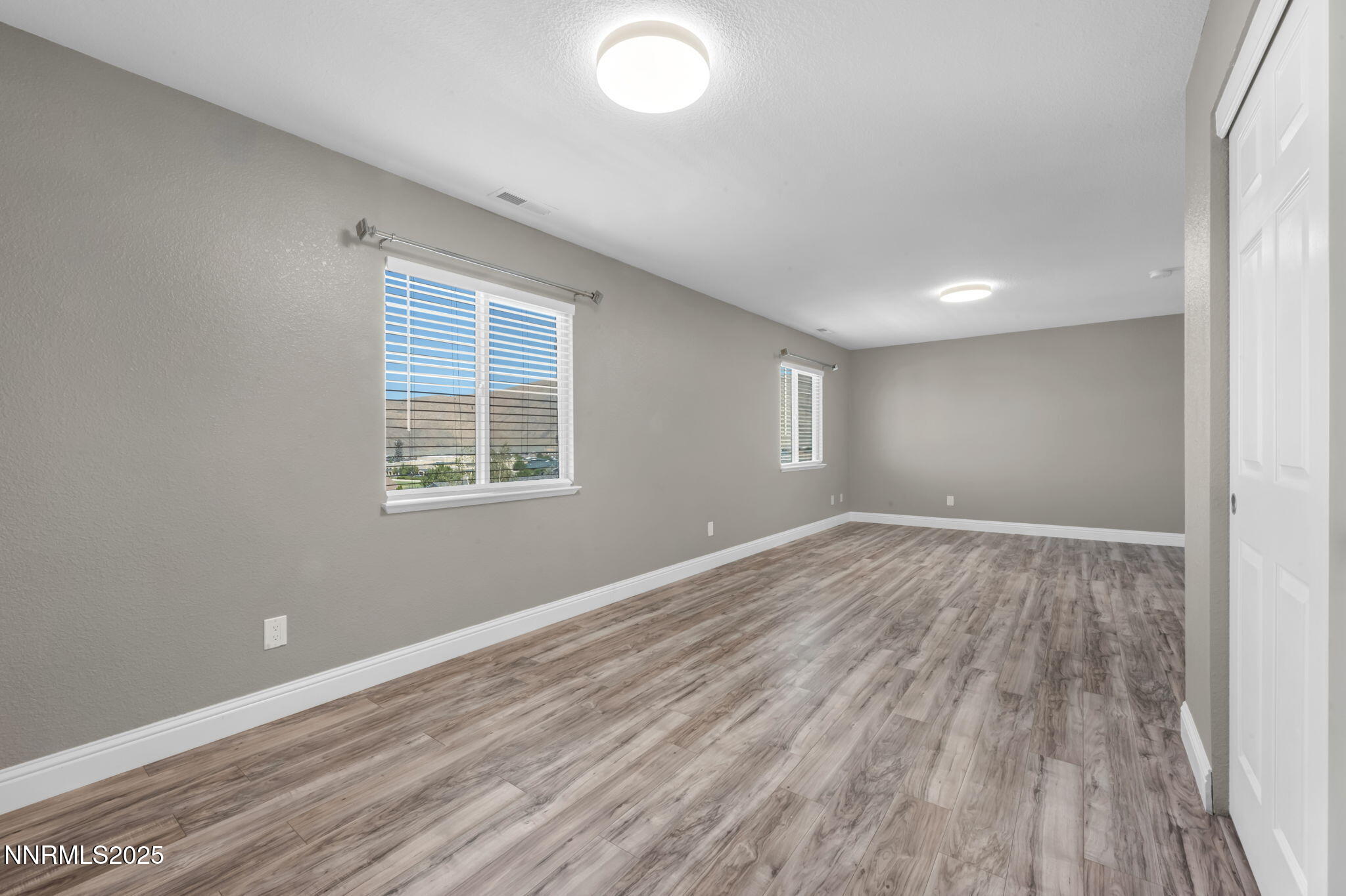 17391 Crystal Canyon Boulevard Reno, NV 89508 - Photo 40 of 63 an empty room with wooden floor and windows