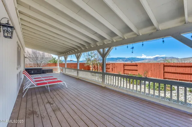 a view of a house with a yard and wooden fence