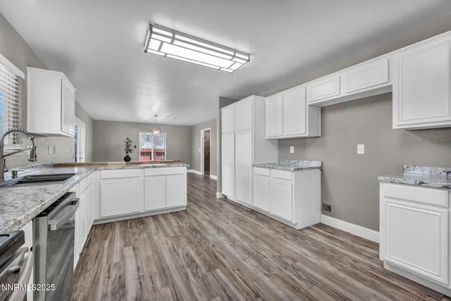 a kitchen with a white wooden cabinets and white appliances
