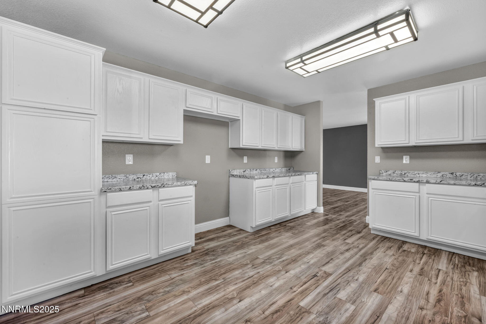 17391 Crystal Canyon Boulevard Reno, NV 89508 - Photo 9 of 63 a kitchen with granite countertop white cabinets and white appliances