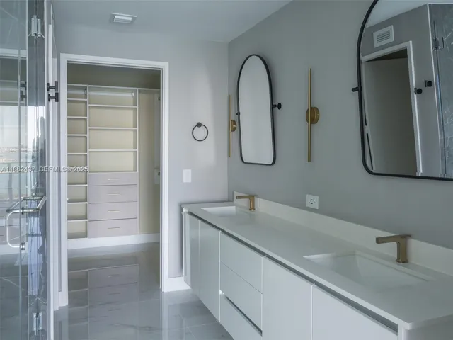 a view of walk in closet with empty racks