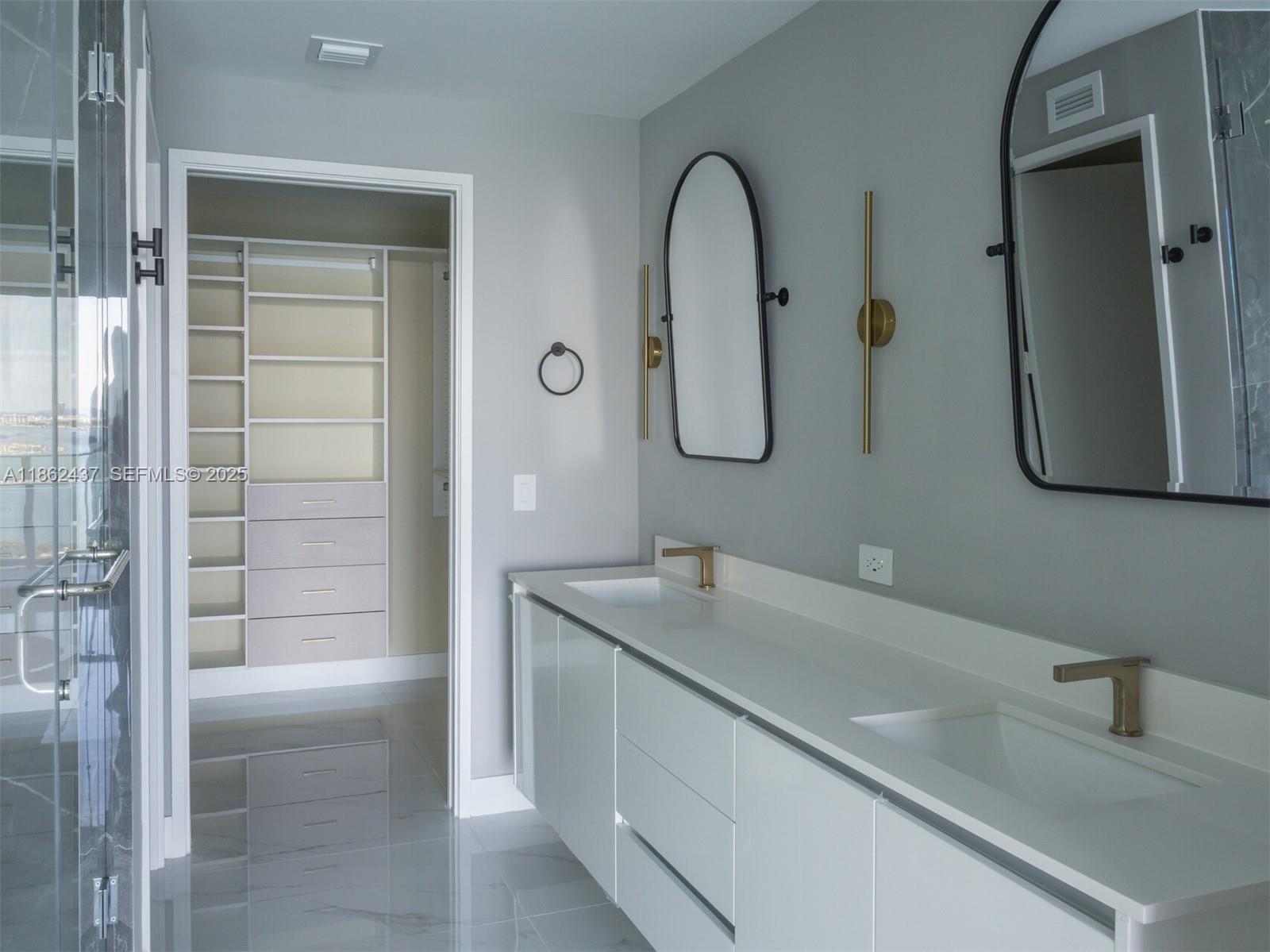 700 Northeast 24th Street, Unit 3304 Miami, FL 33137 - Photo 12 of 64 a bathroom with a sink and a mirror