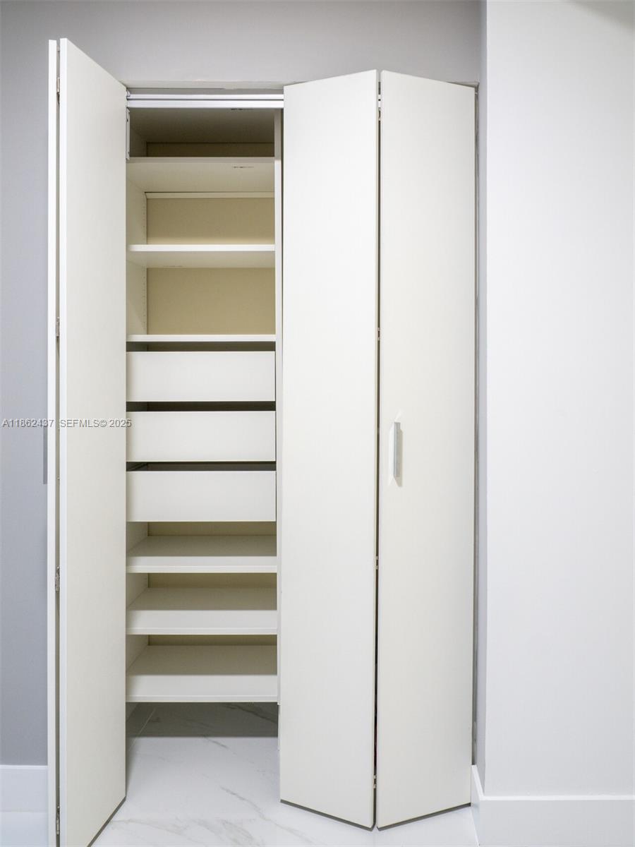 700 Northeast 24th Street, Unit 3304 Miami, FL 33137 - Photo 15 of 64 a view of walk in closet with empty racks