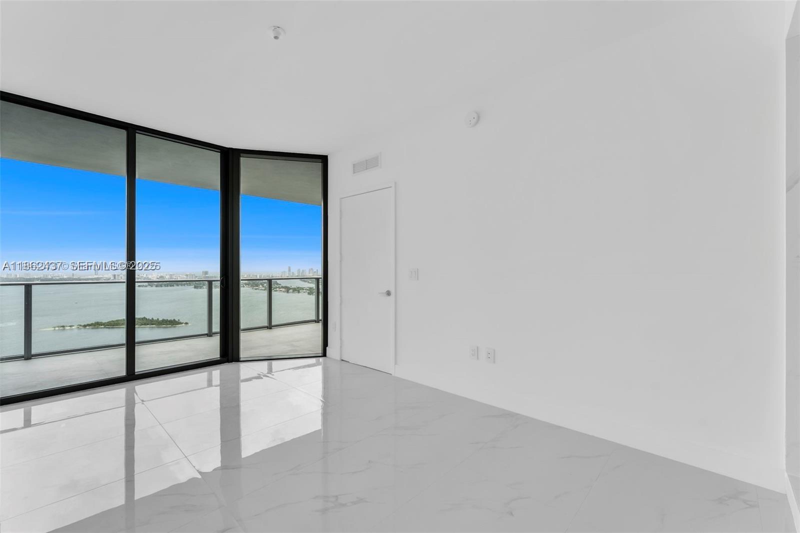 700 Northeast 24th Street, Unit 3304 Miami, FL 33137 - Photo 33 of 64 wooden floor in an empty room with large windows