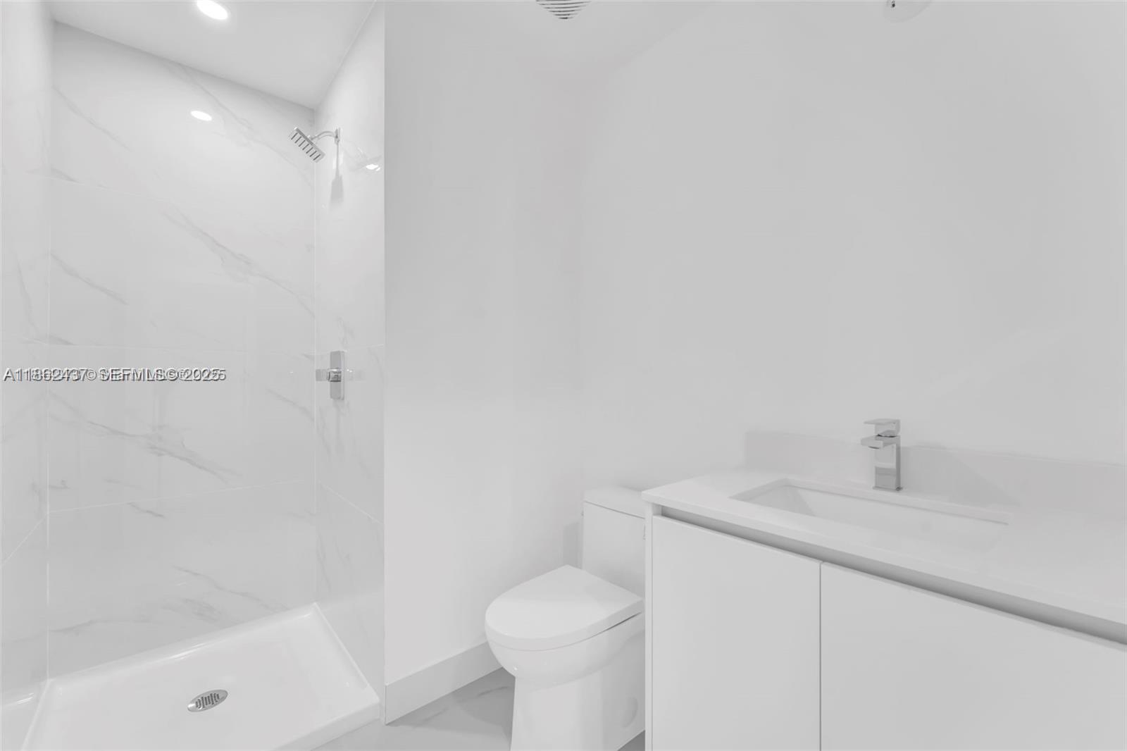 700 Northeast 24th Street, Unit 3304 Miami, FL 33137 - Photo 35 of 64 a bathroom with a sink toilet and shower